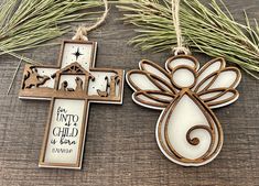 an ornament with a cross and nativity scene hanging from it's side