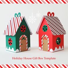 two paper houses with candy canes on them