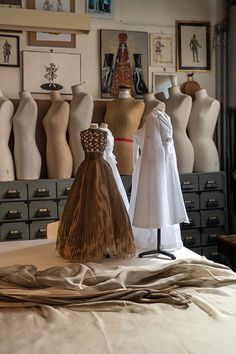 mannequins and dresses on display in a room