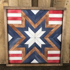 a wooden wall hanging with an american flag design on the outside and red, white, and blue stripes