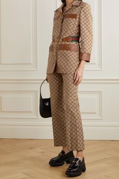 This jacket incorporates a number of the Gucci's signature emblems as a tribute to the archives and traditions of the house. It's made from cotton-blend canvas jacquard-woven with the monogram, which is also featured on the gold-tone buttons. Trimmed in tan leather, it has a slim silhouette with padded shoulders and an elasticated webbing belt with red and green stripes, as well as the recognizable horse bit. Wear yours with the matching pants. Gucci Clothes Women, Gucci Outfits Women, Gucci Outfit, Monogram Jacket, Monogram Outfit, Gucci Jacket, Jacquard Jacket, Gucci Outfits, Royal Outfits