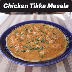 chicken tikka masala in a blue bowl on a wooden table with the words chicken tikka masala above it