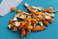 peeled orange peels on a blue cutting board