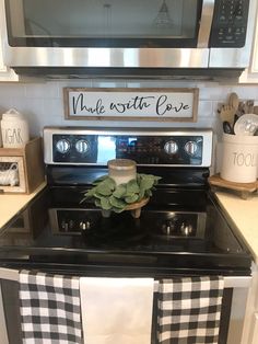 a black and white checkered kitchen towel is hanging on the stove in front of an oven