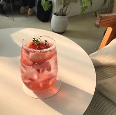 a drink sitting on top of a white table