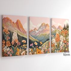 three paintings are hanging on the wall in front of a white wall with flowers and mountains