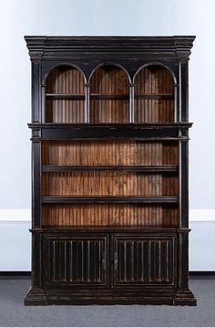 an old fashioned bookcase with wooden shelves