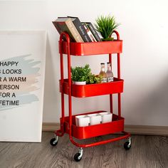 a red cart with books and plants on it