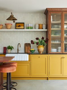 a kitchen with yellow cabinets and counter tops