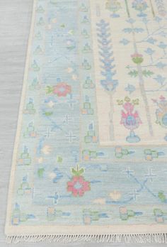 a blue and white rug with flowers on it