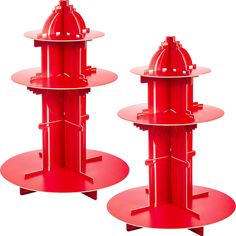 two red fire hydrants sitting next to each other on top of metal bases,