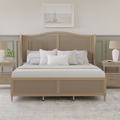 a bedroom with a bed, nightstands and two lamps on either side of the bed