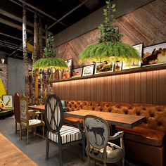 a restaurant with tables, chairs and pictures on the wall above them is decorated with palm trees