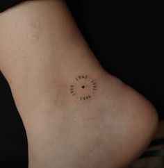 a small tattoo on the back of a woman's leg that reads love is in the air