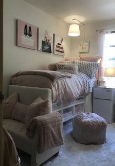 a bedroom with a bed, chair and ottoman in it's corner next to a window