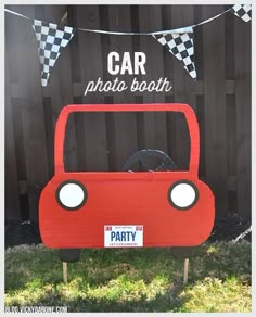 a red car birthday party decoration with checkered flags