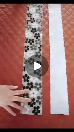 someone is making a paper strip with black and white dots