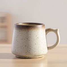 a coffee cup sitting on top of a wooden table