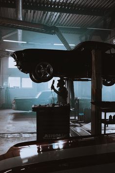 a man working on a car in a garage