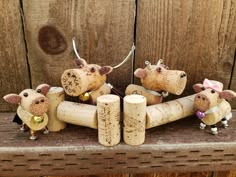 four little mice are sitting on top of wine corks