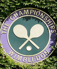 there is a purple and green sign with two tennis racquets on it