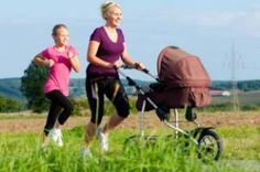 two women jogging with a stroller and baby in the back, on a sunny day