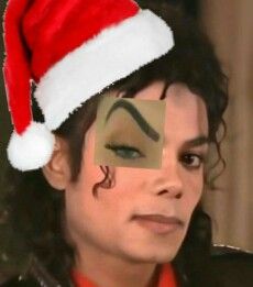 a man with his face painted to look like michael jackson is wearing a santa hat