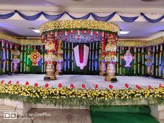 the stage is decorated with flowers and decorations