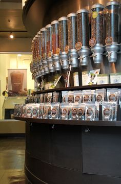 there are many coffees on the counter in this store, and one is full of them