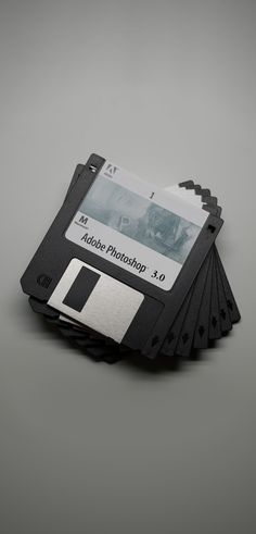 a stack of black and silver floppy drives sitting next to each other on top of a table