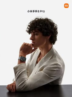 a woman sitting at a table with her hand on her chin and looking off to the side