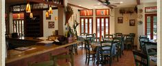 the inside of a restaurant with tables and chairs