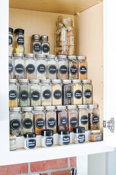 an organized pantry with jars and spices