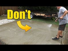 a man using a pressure washer to clean concrete