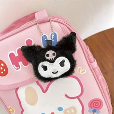 a pink backpack with a black and white bear on it