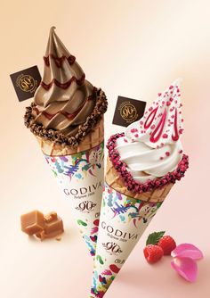 two ice cream cones with chocolate toppings on them