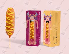 a hot dog on a stick in front of a cardboard box and an empty carton