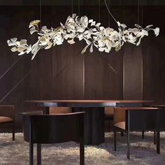 a dining room table with chairs and a chandelier hanging from it's ceiling