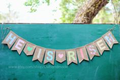 a banner that says he is married hanging from the side of a green wooden wall