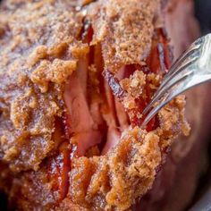 a close up of food on a plate with a fork in it's mouth