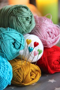 several skeins of yarn sitting on top of a table next to each other