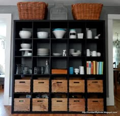 an open bookcase filled with lots of dishes and bowls on top of wooden crates