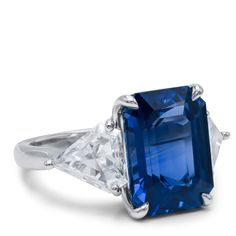 Platinum Sapphire and Diamond Three-Stone Ring: 9.85ct of emerald cut sri lanka natural ceylon blue sapphire 2 triangle cut Diamonds on its side, totaling 2.15cts EC AGI certified Trillion Cut Sapphire Jewelry, Classic Trillion Cut Sapphire Ring, Sapphire Trillion Cut Ring, Trillion Cut Blue Sapphire Ring For Gift, Luxury Trillion-cut Sapphire Ring, Blue Gia Certified Emerald Ring For Formal Occasions, Trillion Cut Sapphire Ring Fine Jewelry, Blue Sapphire Ring With Radiant Diamond Cut, Trillion Cut Sapphire Ring Gift