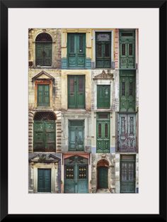 an old building with green doors and shutters on the front, framed in black frame