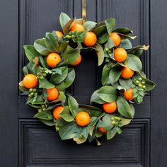 an orange wreath is hanging on the front door