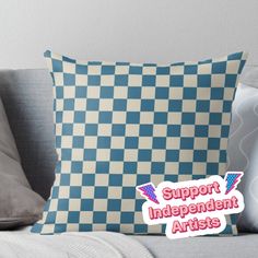 a blue and white checkerboard pillow with the words support independent artists on it