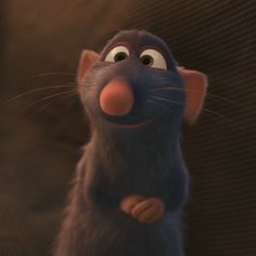 a cartoon rat with big ears standing in front of a brown wall and looking up at the camera