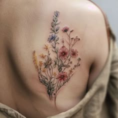 a woman's back with flowers on it