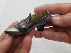 This 1930's shoe is made of pewter and has a lovely detailed buckle that features the rotunda and government buildings of Washington DC.  It has a nice weight to it and would be a great addition to the miniture collector, travel memorabilia,  sewing enthusiasts and a unique accent for your home décor design. This shoe is in good condition.  We take care to inspect and clean our vintage items before offering them to you for sale. By so doing we can ensure that you are getting a quality item. We also take detailed photos.  Vintage items have the patina of time and the decades they have spent out in the world. This is part of the charm and appeal of buying well designed vintage and  antique items! Dimensions 1.25 ins./3.17 cm. Overall Height  2.25 ins / 7.62 cm. Long  1 ins./ 2.54 cm. Opening 1930s Shoes, Travel Memorabilia, Pin Cushion, Antique Items, Pin Cushions, Collectible Figurines, Washington Dc, High Heel Shoes, High Heel