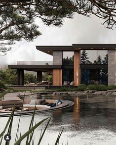 a boat is parked in front of a modern house on the water's edge